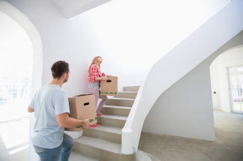 Moving team navigating stairs in a Camberwell property